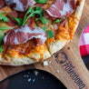 delicious cooked pizza on a wooden pizza peel