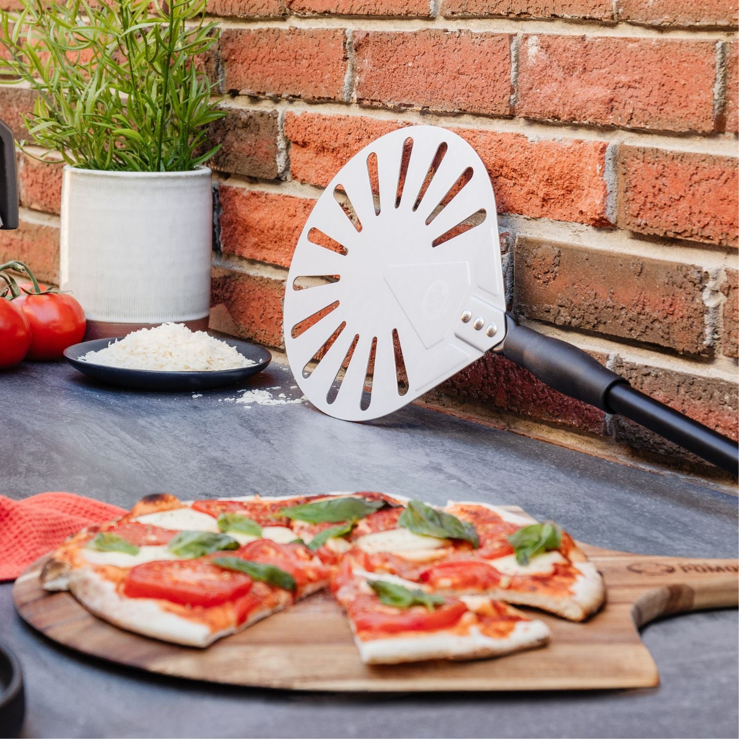 Cooked pizza and aluminum turning pizza peel - Chef Pomodoro