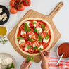 Preparing Pizza on a Wooden Pizza Peel